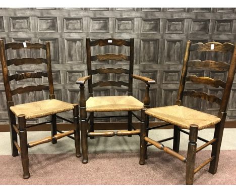 FIVE OAK AND ELM LADDER BACK DINING CHAIRS OF 18TH CENTURY DESIGN with rush seats on turned legs and stretchers, comprising f