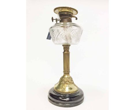 LATE 19TH CENTURY BRASS AND GLASS OIL LAMP embossed in relief with Art Nouveau stylised foliate designs with an etched glass 