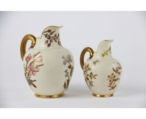 Two Royal Worcester blush ivory jugs shape 1094, each baluster jug with gilt reeded handle and floral decoration, 15cm high a