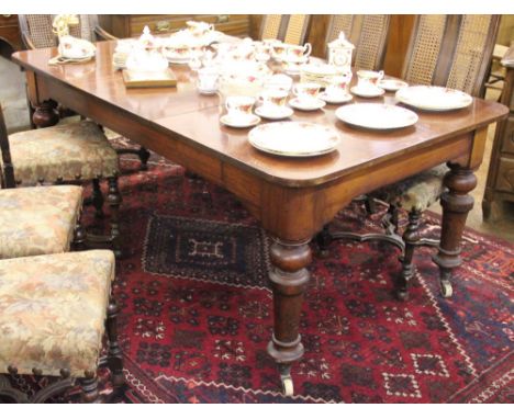 A Victorian mahogany dining table, on turned and tapered legs, fitted ceramic casters, 75cm H x 82cm L x 109cm W