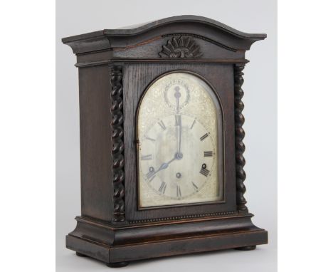 A 1920's oak mantel clock, silvered Roman numeral dial with kienzle movement striking on five gongs, 40cm 