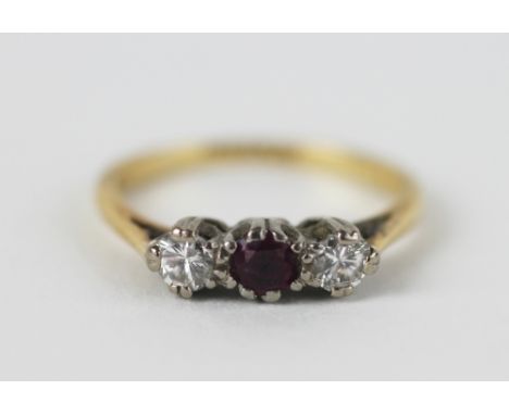 A ruby and diamond three stone ring, the central ruby (untested) flanked by a brilliant cut diamond to either side, claw set 