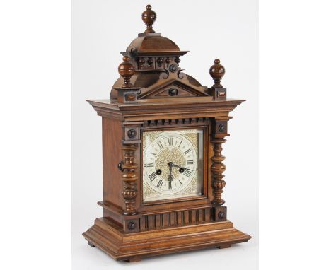 A Junghans walnut mantel clock, architectural case and decorative Roman numeral dial and movement striking on a gong, 53cm