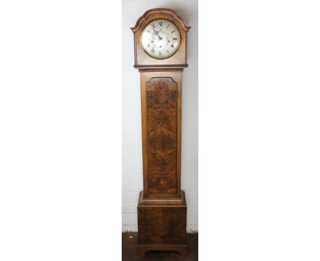 A 20th century German figured walnut grandmother clock, 21cm silvered dial with Roman numerals and movement striking on eight