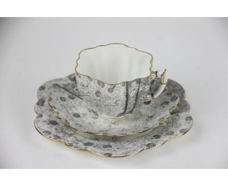 A Foley China Wileman Shelley trio, printed with a floral pattern in grey, grey printed mark and Rd no 115510