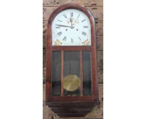 An early 20th century walnut eight day wall clock, with domed top and movement striking on seven gongs, 73cm