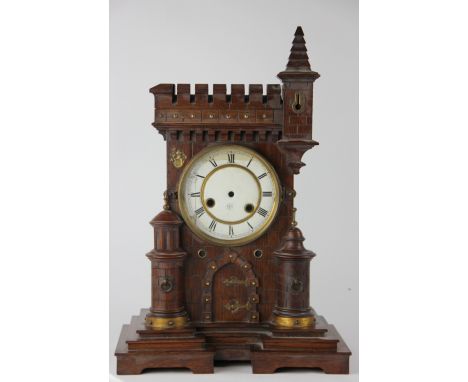 A late 19th century German carved oak mantel clock, in the form of a castle entrance, enamel dial signed 'Junghons' (damaged 