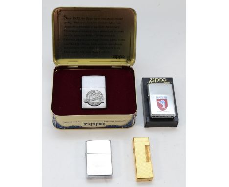 A Dunhill rollagas cigarette lighter, gold plated with engine turned case, together with three Zippo cigarette lighters. (4) 