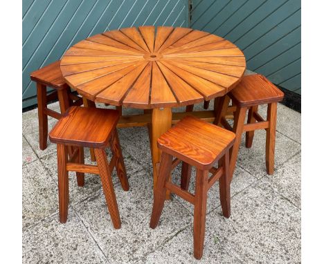 A child's pine garden table, 90cm diameter with six matching pine stools and a drum BBQ. 