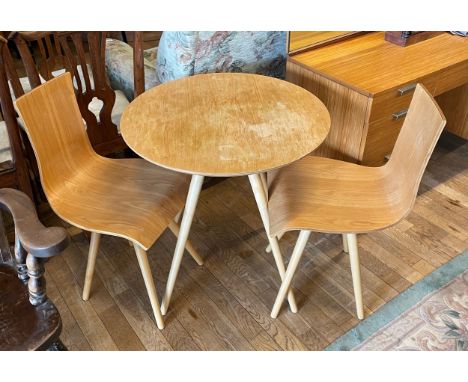 A modern organic three piece bistro set, comprising circular table on four splayed tapered legs, 70cm diameter, with a pair o