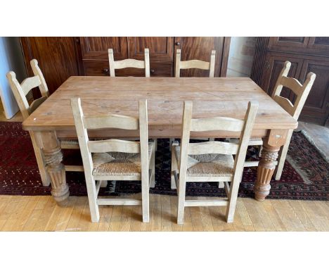 A country pine dining suite, comprising rectangular plank top table, having single frieze drawers to each end, raised on turn