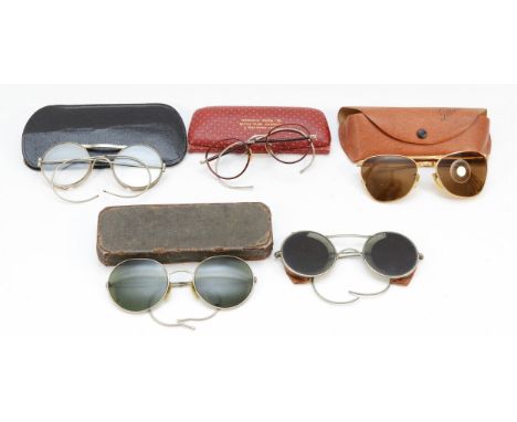 Two pairs of early 20th century sunglasses, together with a later Polaroid cased pair and two cased pairs of reading glasses.