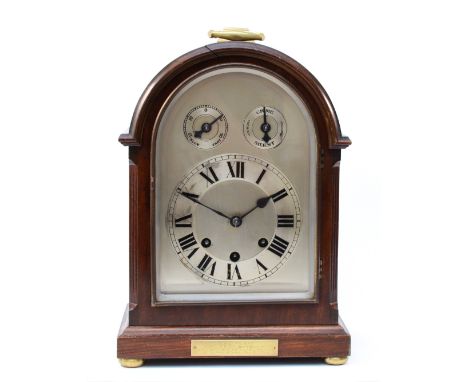 An early 20th century mahogany bracket clock, having arched architectural case, silvered dial and chapter ring with Roman num