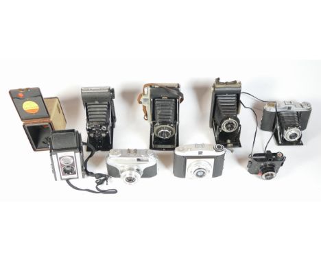 Nine mixed cameras to include an Empire Baby, a Kershaw Eight-20 Penguin and a Kodak Brownie. Together with a Polaroid flashg
