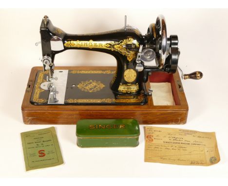 A manual operated Singer sewing machine, circa 1939, model EC109721, cased with key, instructions and original purchase recei