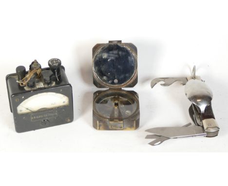 A Kelvin &amp; Hughes 1917 brass compass, an electrical tester and a camping fork 