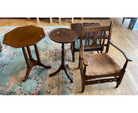 An oak fireside or chimney armchair, circa 1930s, with slatted back and bowed leather seat, the carved incised front stretche