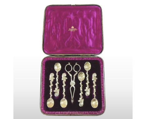 A set of six 19th century gilt coffee spoons, with a pair of matching sugar tongs, each having ornate cast vine decoration, r