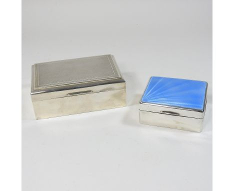 An Art Deco silver table cigarette box, the hinged lid with blue enamel decoration, Birmingham 1921, 9cm wide, together with 