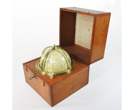 A rare late 19th century Cary ship's navigator's celestial globe, mounted in a brass directional horizon band, within a detac