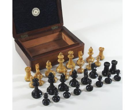 An early 20th century wooden chess set, tallest 7cm, in a walnut case, bearing a label for I &amp; W Taylor, Leicester. 22cm