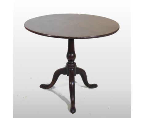 A George III and later mahogany occasional table, the hinged circular top, on a turned column and tripod base, 88cm