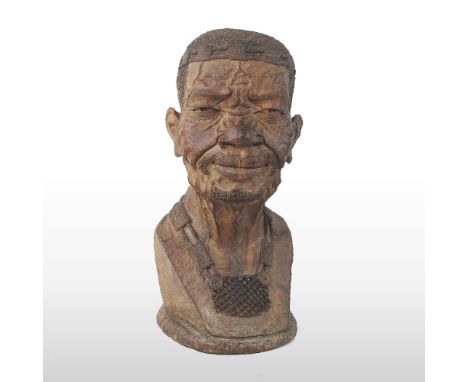 An African carved hardwood portrait bust, of a man, signed Norman Chopotercra and dated 99, 32cm high