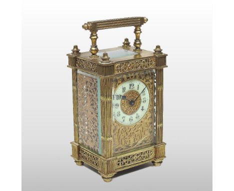 An ornate 19th century continental brass cased carriage clock, having a white enamel dial, with Arabic hours, inset with orna