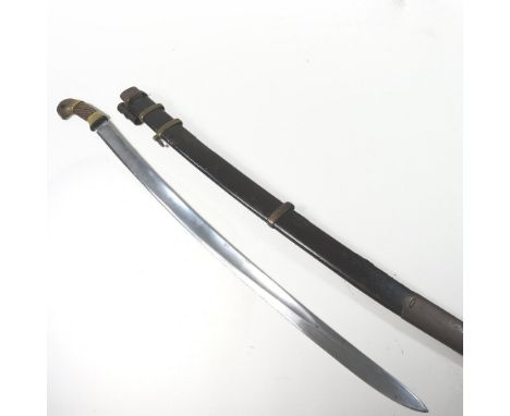 A World War II era Russian Cossack Shashka sabre, having a carved wooden and engraved brass mounted grip, with a steel blade,