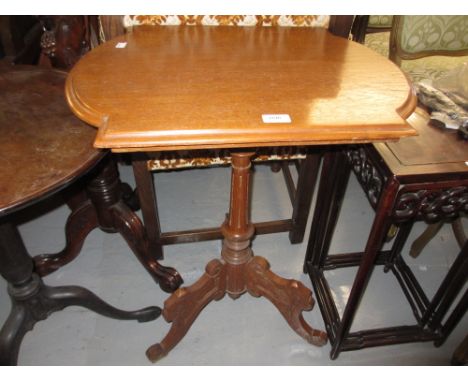 Victorian walnut pedestal table, the shaped top above a turned column support and tripod base