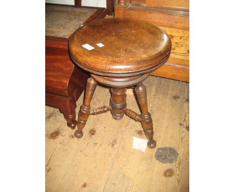 Beechwood piano stool with circular revolving seat on turned tripod base