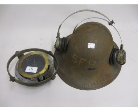 World War II military helmet, a ships compass on gimbal with M.O.D. arrow mark, No. 6B / 1672 and a pair of 1940's ear phones