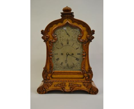 19th Century pale oak bracket clock, the shaped case with profuse carved decoration, the silvered dial with Roman numerals, s