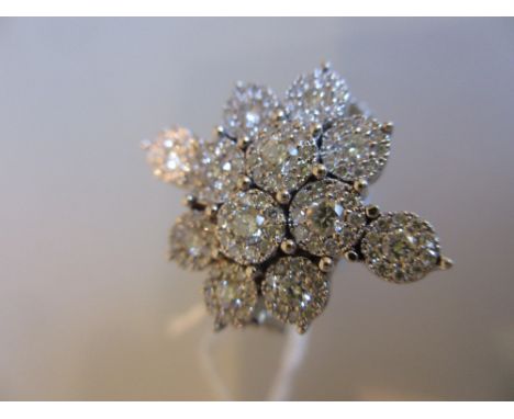 18ct White gold multiple diamond cluster ring in the form of a snowflake, approximately 1.30ct