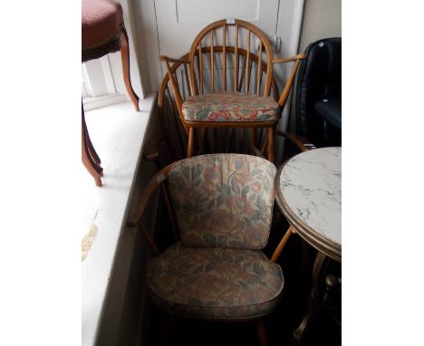 Mid 20th Century Ercol stick back low seat elbow chair together with a similar open elbow chair and a rocking chair