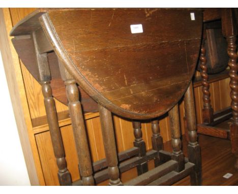 Small oak oval gate leg table on turned supports and an oak occasional table on barley twist supports