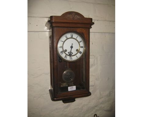 Small early 20th Century Continental oak cased wall clock, the enamel dial with Roman numerals and two train movement