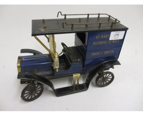 Tin plate model of a vintage car with Plumbing Service advertising