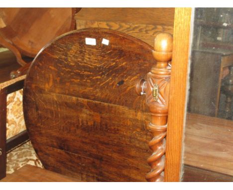 George III oak circular pedestal table, the tilt top above a bird cage and turned column support with tripod