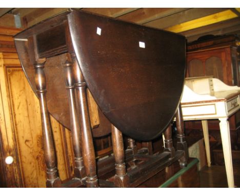 Ercol dark oak dining room suite comprising:-  drop-leaf table, four chairs and a dresser, together with 1930's oak single do