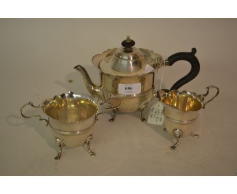 Silver three piece tea service of circular shaped design with lions paw feet and scroll handles, Chester 1898