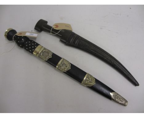 Scottish dirk with metal mounted scabbard together with an Arab dagger with leather scabbard