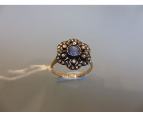 Antique style white and yellow metal set sapphire and diamond flower head ring of pierced design