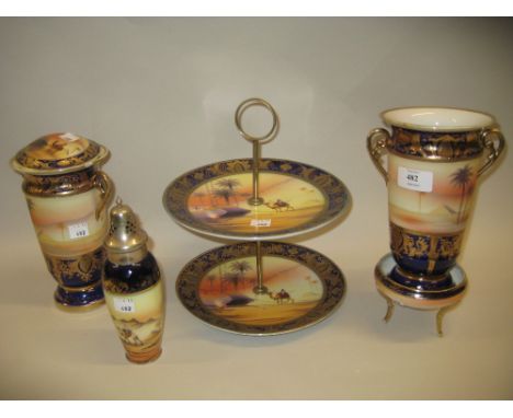 Pair of Noritake porcelain vases decorated with Bedouin scenes on a blue and gilt ground together with a similar powder bowl 