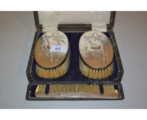 Pair of Chinese silver backed brushes decorated with bamboo together with a matching comb in original box