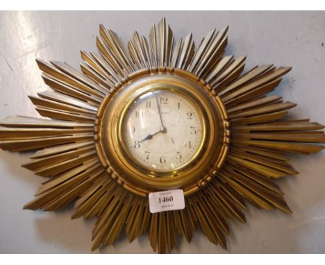 Gilt sunburst wall clock with enamel dial and eight day movement