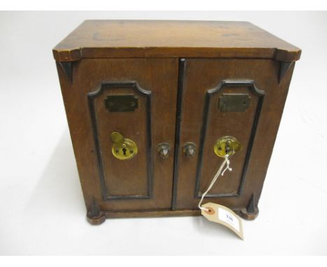 19th Century oak tea caddy in the form of a safe with two doors enclosing three small drawers