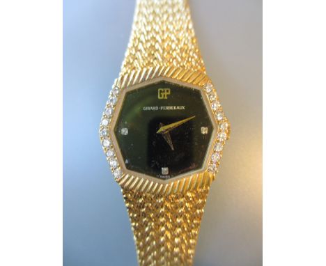 Girard Perregaux, ladies wristwatch, the two piece gold plated case with black enamel diamond set dial and diamond set bezel,