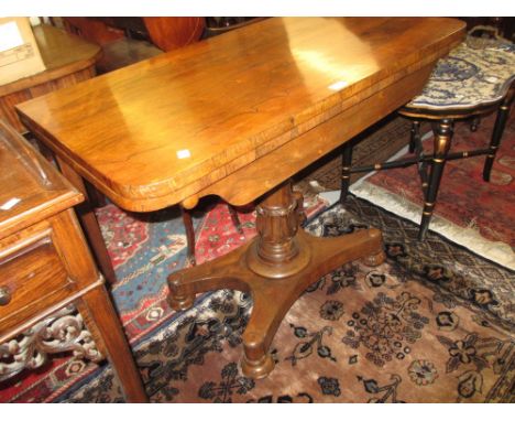 William IV rosewood rectangular fold-over card table with a turned and tulip carved column support and quadruped base