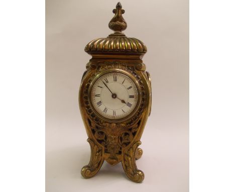 Mid 19th Century French gilt brass mantel clock, the pierced cast case with mask head decoration and circular enamel dial wit